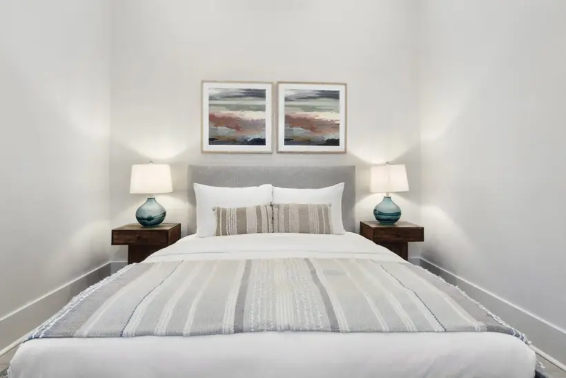 Bedroom 1 with a queen bed and matching lamps