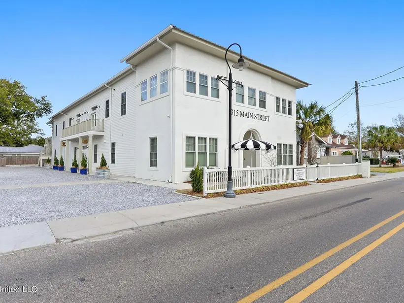 315A Main Street seen from the street with lamp post and palm trees